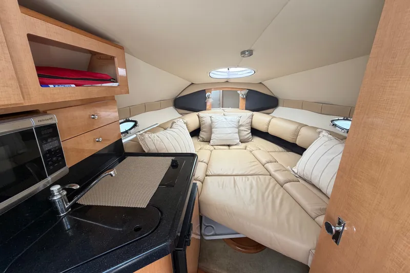 Slide: The Image of Interior of 2016 Glastron GS 259 boat with cozy seating and kitchenette. - 41