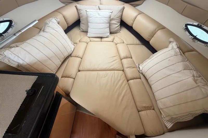 Slide: The Image of Interior cabin of 2016 Glastron GS 259 boat with beige cushions and pillows. - 60