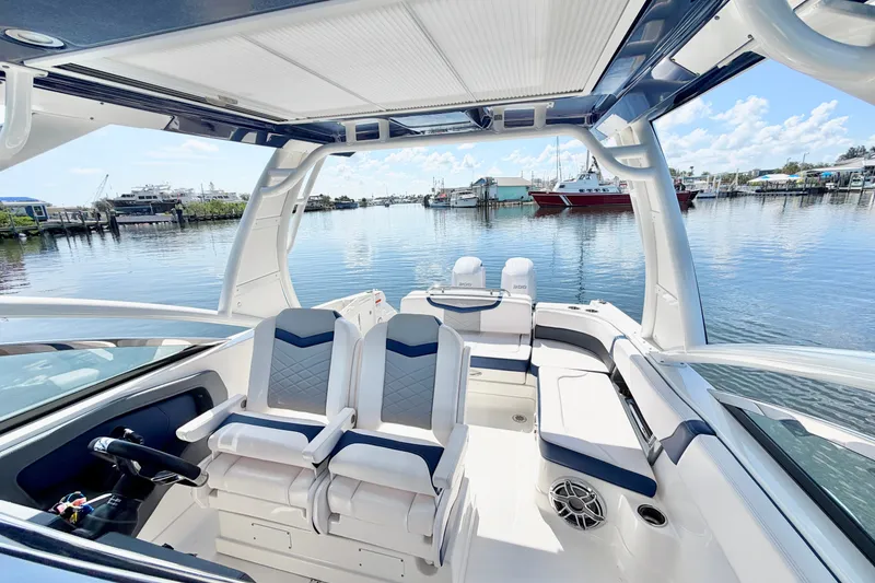 Slide: The Image of 2021 Chaparral 280 OSX boat interior with luxurious seating and waterfront view. - 24