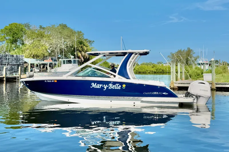 Slide: The Image of 2021 Chaparral 280 OSX boat named "Mar-y-Belle" docked on calm water. - 6