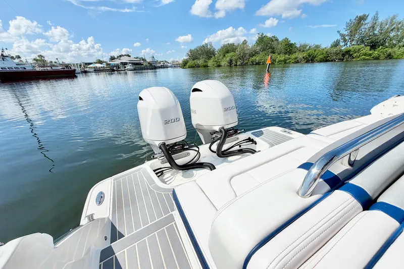 Slide: The Image of 2021 Chaparral 280 OSX boat with twin Yamaha 200 engines on a sunny day. - 10