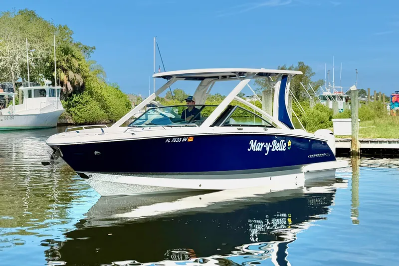 The Image of 2021 Chaparral 280 OSX boat named "Mary-Belle" on calm water near a dock. - 0