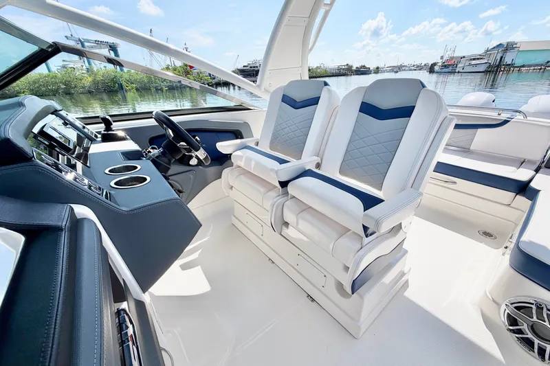 Slide: The Image of Interior of 2021 Chaparral 280 OSX boat with luxurious seating and modern dashboard. - 19