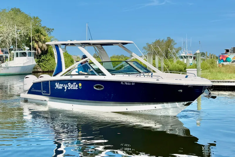 Slide: The Image of 2021 Chaparral 280 OSX boat named "Mar-y-Belle" docked on a sunny day. - 4
