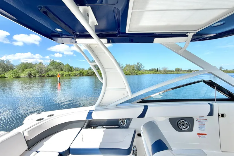 Slide: The Image of 2021 Chaparral 280 OSX boat interior with sleek seating and scenic water view. - 15