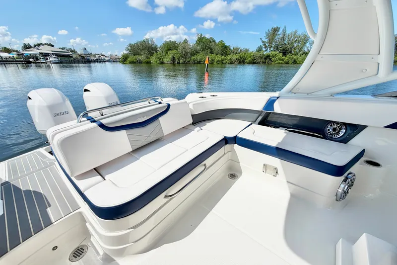 Slide: The Image of 2021 Chaparral 280 OSX boat interior with seating, water view, and twin engines. - 14