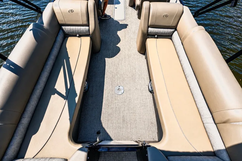 Slide: The Image of The image shows the interior of a 2022 Avalon Catalina Platinum Quad Lounge boat with beige seating. - 8