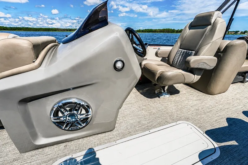 Slide: The Image of 2022 Avalon Catalina Platinum Quad Lounge boat interior with luxurious seating and sleek dashboard. - 10