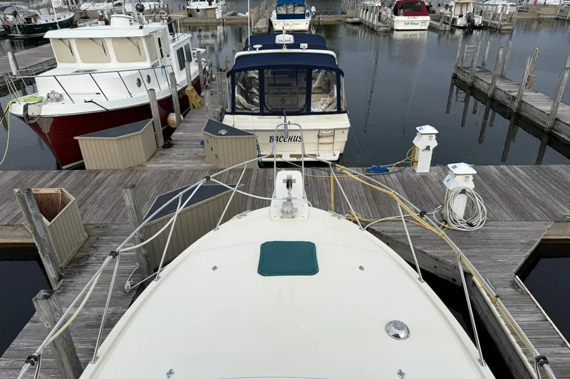 Slide: The Image of 1987 Chris-Craft 362 Catalina docked at a marina with other boats. - 7