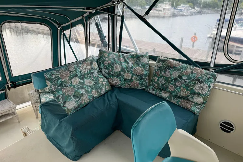Slide: The Image of 1987 Chris-Craft 362 Catalina interior with floral cushions and marina view. - 10