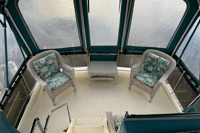 Slide: The Image of Interior of 1987 Chris-Craft 362 Catalina with wicker chairs and floral cushions. - 11