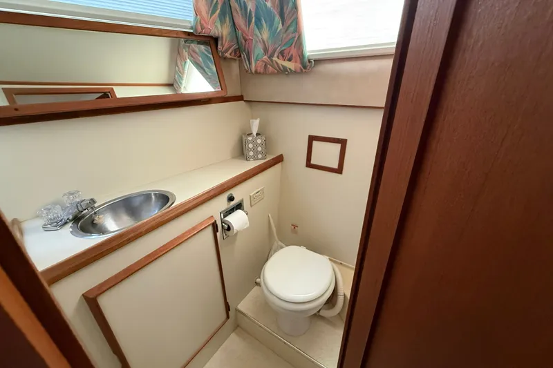 Slide: The Image of 1987 Chris-Craft 362 Catalina bathroom with sink, toilet, and mirror. - 24