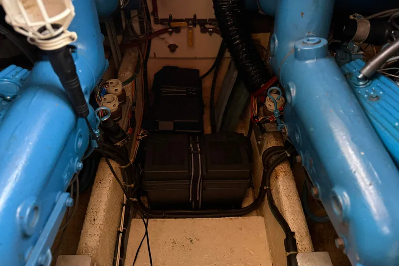 Slide: The Image of Engine compartment of 1987 Chris-Craft 362 Catalina, showcasing blue engine components and wiring. - 39