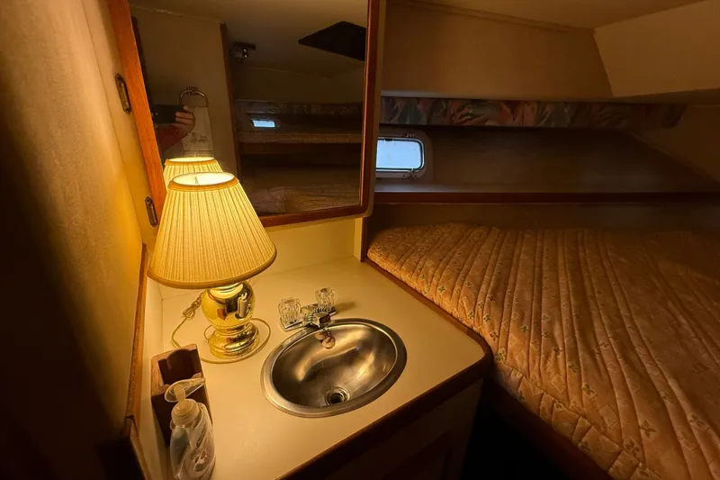 Slide: The Image of 1987 Chris-Craft 362 Catalina cabin interior with sink, lamp, and cozy bed. - 19