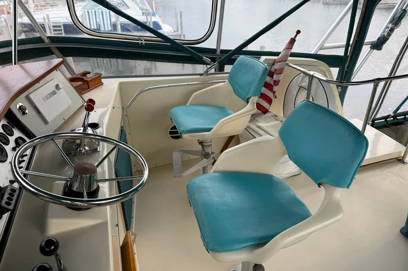 Slide: The Image of 1987 Chris-Craft 362 Catalina helm with blue seats and steering wheel, dockside view. - 9