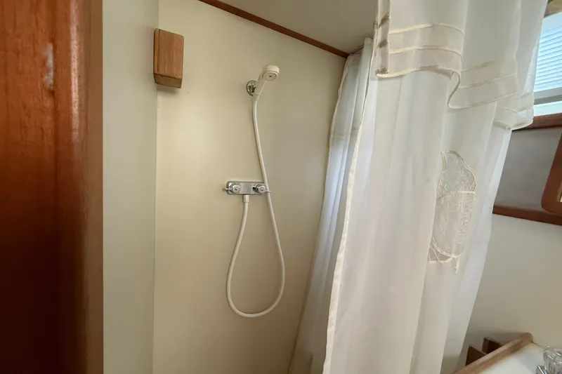 Slide: The Image of Shower area in 1987 Chris-Craft 362 Catalina yacht with curtain and showerhead. - 25