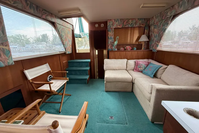 Slide: The Image of Interior of 1987 Chris-Craft 362 Catalina yacht with cozy seating and nautical decor. - 14