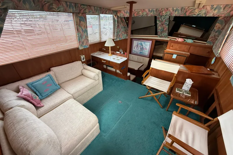 Slide: The Image of Interior of 1987 Chris-Craft 362 Catalina yacht with cozy seating and nautical decor. - 13