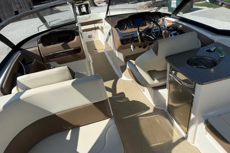 Slide: The Image of 2014 Chaparral 307 SSX boat interior with luxurious seating and modern dashboard. - 12