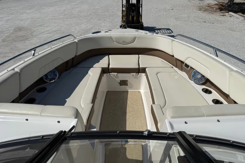 Slide: The Image of 2014 Chaparral 307 SSX boat interior with beige seating and cup holders. - 9