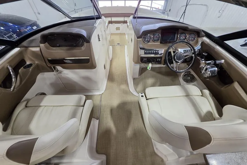 Slide: The Image of Interior view of 2014 Chaparral 307 SSX boat, featuring dual seats and a modern dashboard. - 13