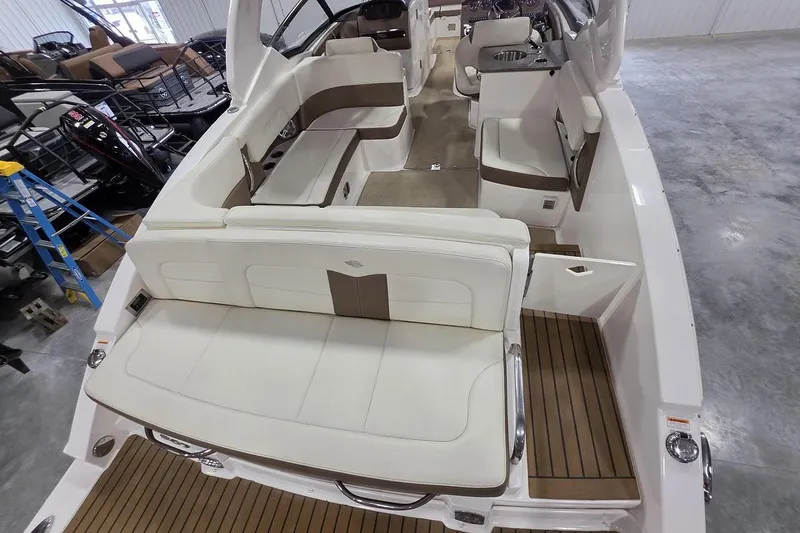Slide: The Image of 2014 Chaparral 307 SSX boat interior with white seating and wood accents. - 8
