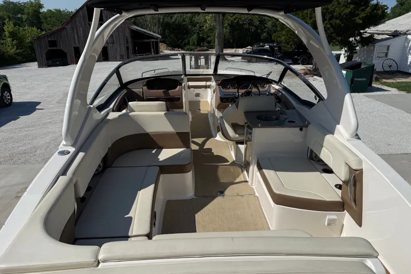 Slide: The Image of 2014 Chaparral 307 SSX boat interior with spacious seating and modern dashboard. - 6