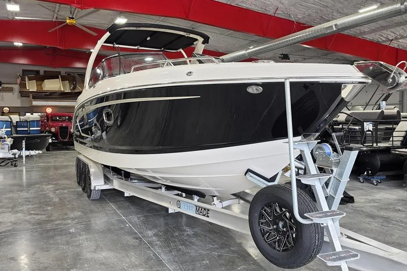 Slide: The Image of 2014 Chaparral 307 SSX boat on trailer in showroom with red ceiling. - 6