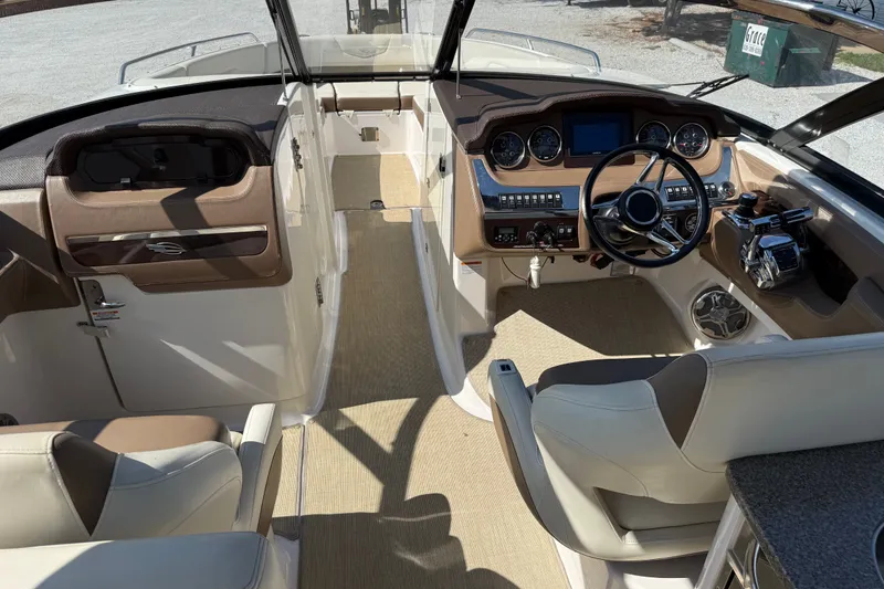 Slide: The Image of 2014 Chaparral 307 SSX boat interior with modern dashboard and steering wheel. - 8