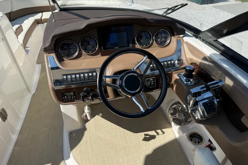 Slide: The Image of 2014 Chaparral 307 SSX boat dashboard with steering wheel and control panel. - 11