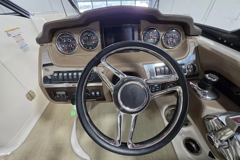 Slide: The Image of 2014 Chaparral 307 SSX boat dashboard with steering wheel and instrument panel. - 14