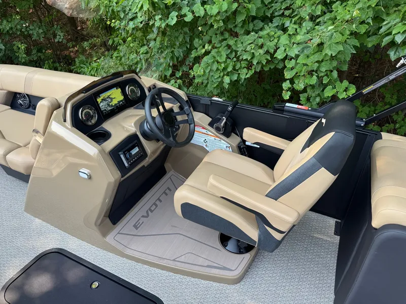 Slide: The Image of The image shows the cockpit of a 2027 Evotti 521QL boat with beige seats and a modern helm. - 16