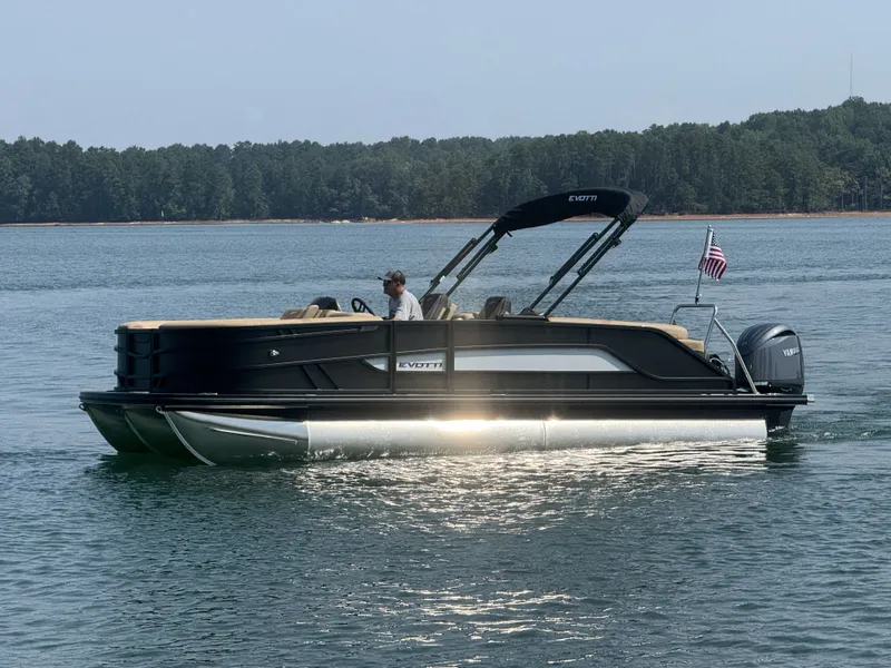 Slide: The Image of A modern pontoon boat by Evotti, model 521QL, year 2027, cruising on a calm lake. - 26