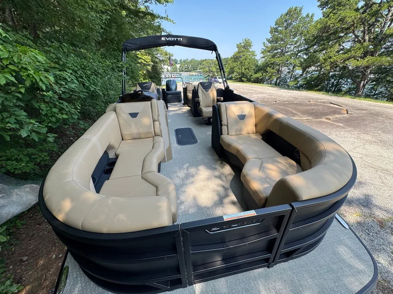 Slide: The Image of The image shows a 2027 Evotti 521QL pontoon boat with beige seating and black railing. - 13