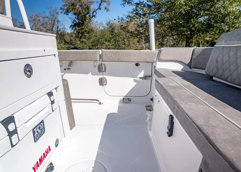 Slide: The Image of The image shows the cockpit of a 2027 Sea Hunt Ultra 265 SE boat with gray upholstery. - 9