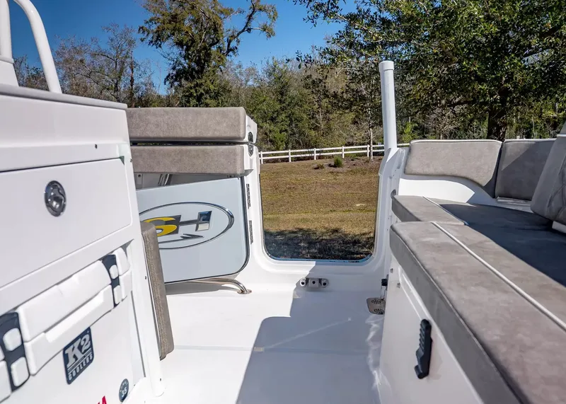 Slide: The Image of The image shows the cockpit of a 2027 Sea Hunt Ultra 265 SE boat with gray upholstery. - 11