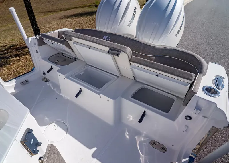 Slide: The Image of The image shows the stern of a Sea Hunt Ultra 265 SE boat with two Yamaha engines. - 13