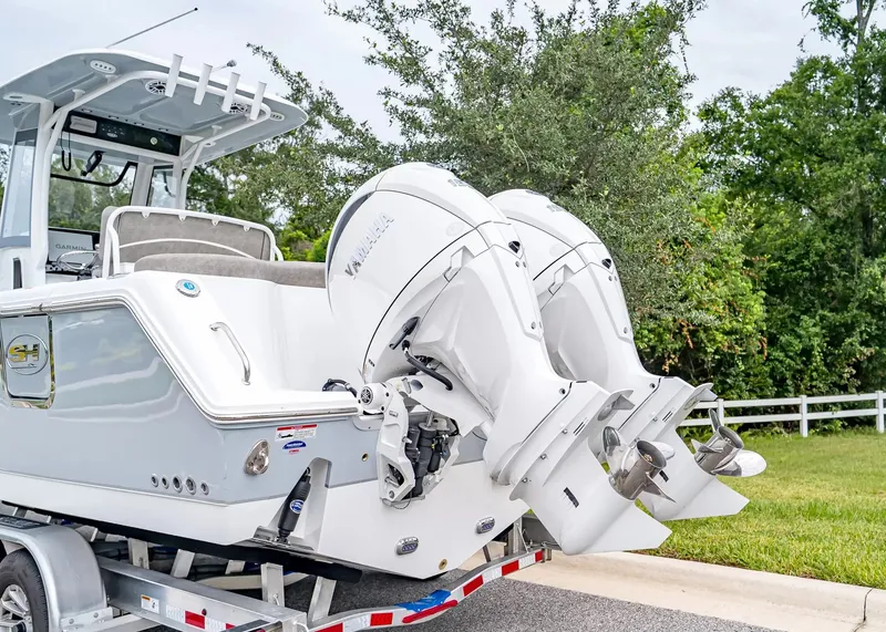 Slide: The Image of The image shows a 2027 Sea Hunt Ultra 265 SE boat with two outboard engines. - 3