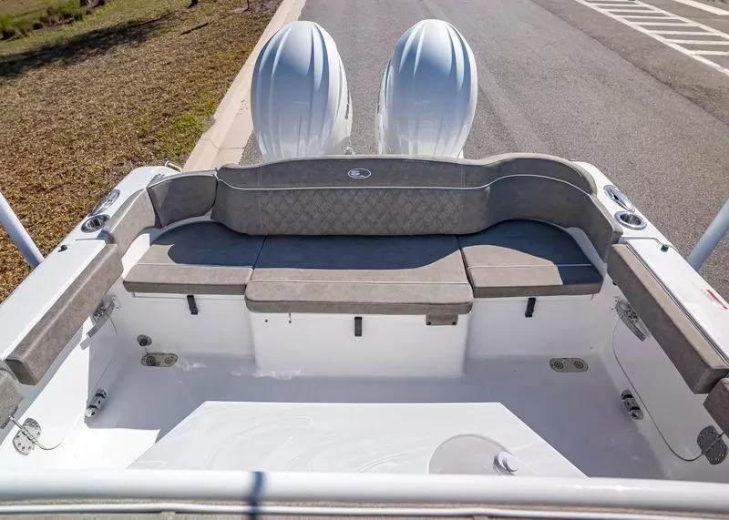 Slide: The Image of The image shows the stern of a 2027 Sea Hunt Ultra 265 SE boat with gray upholstery. - 6