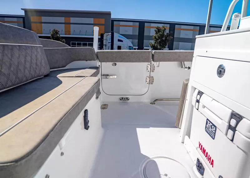 Slide: The Image of The image shows the cockpit of a 2027 Sea Hunt Ultra 265 SE boat with beige upholstery. - 10