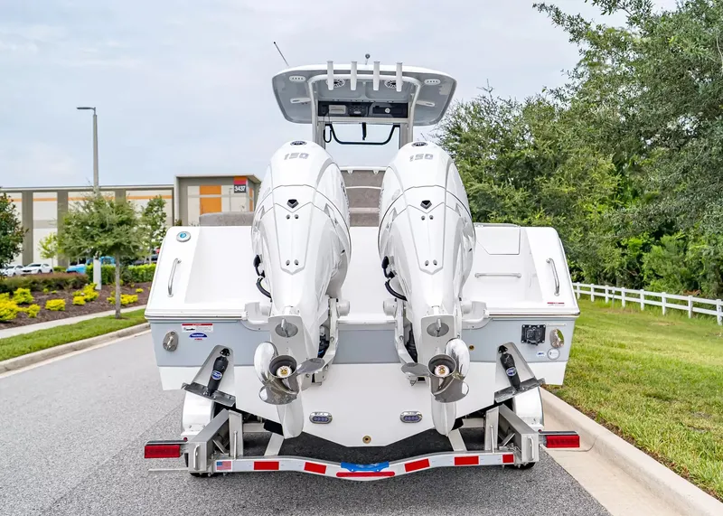 Slide: The Image of The image shows a 2027 Sea Hunt Ultra 265 SE boat with twin outboard engines on a trailer. - 4
