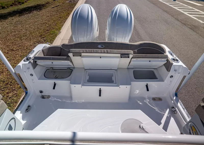 Slide: The Image of The image shows the stern of a Sea Hunt Ultra 265 SE boat with dual engines. - 14
