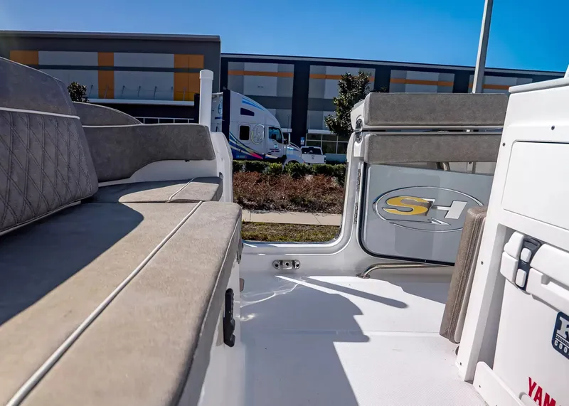 Slide: The Image of The image shows the interior of a 2027 Sea Hunt Ultra 265 SE boat with gray upholstery. - 12