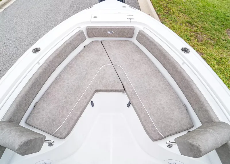 Slide: The Image of The image shows the bow area of a Sea Hunt Ultra 245 SE boat with cushioned seating. - 22