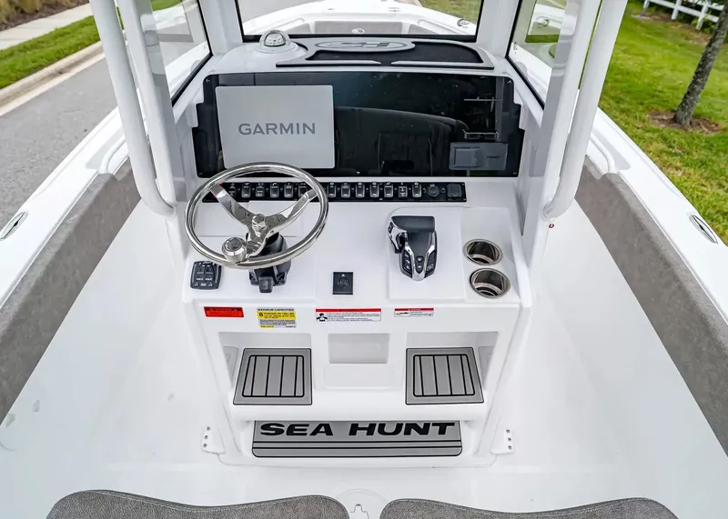 Slide: The Image of The image shows the helm of a Sea Hunt Ultra 245 SE boat with Garmin navigation. - 16