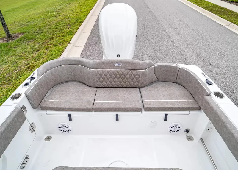 Slide: The Image of The image shows the stern of a 2027 Sea Hunt Ultra 245 SE boat with cushioned seating. - 6