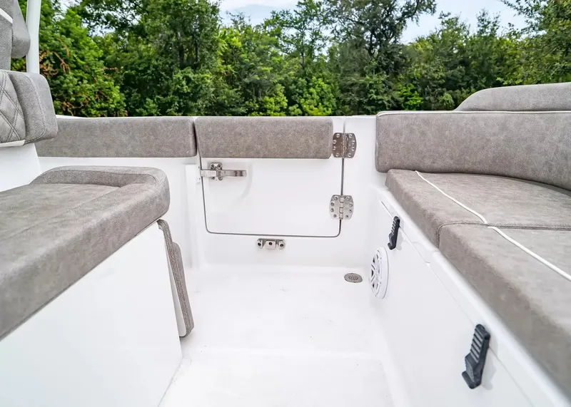 Slide: The Image of The image shows the interior of a Sea Hunt Ultra 245 SE boat with gray upholstery. - 8
