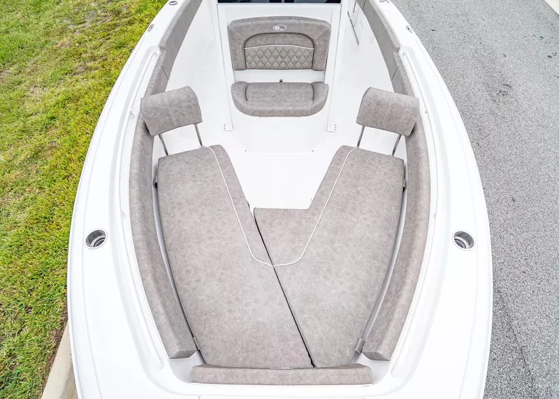 Slide: The Image of The image shows the bow area of a Sea Hunt Ultra 245 SE boat with cushioned seating. - 23