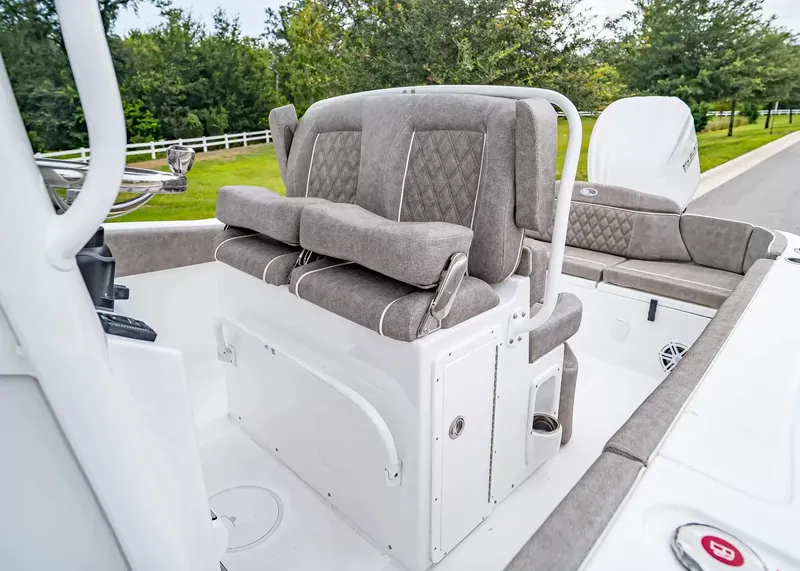 Slide: The Image of The 2027 Sea Hunt Ultra 245 SE features cushioned seating and a modern helm console. - 19