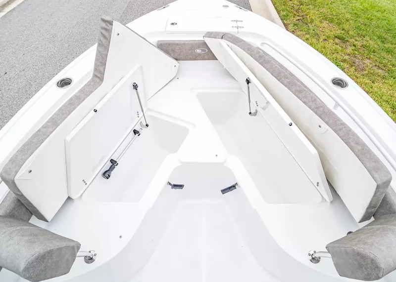 Slide: The Image of The image shows the bow area of a Sea Hunt Ultra 245 SE boat with seating and storage. - 25
